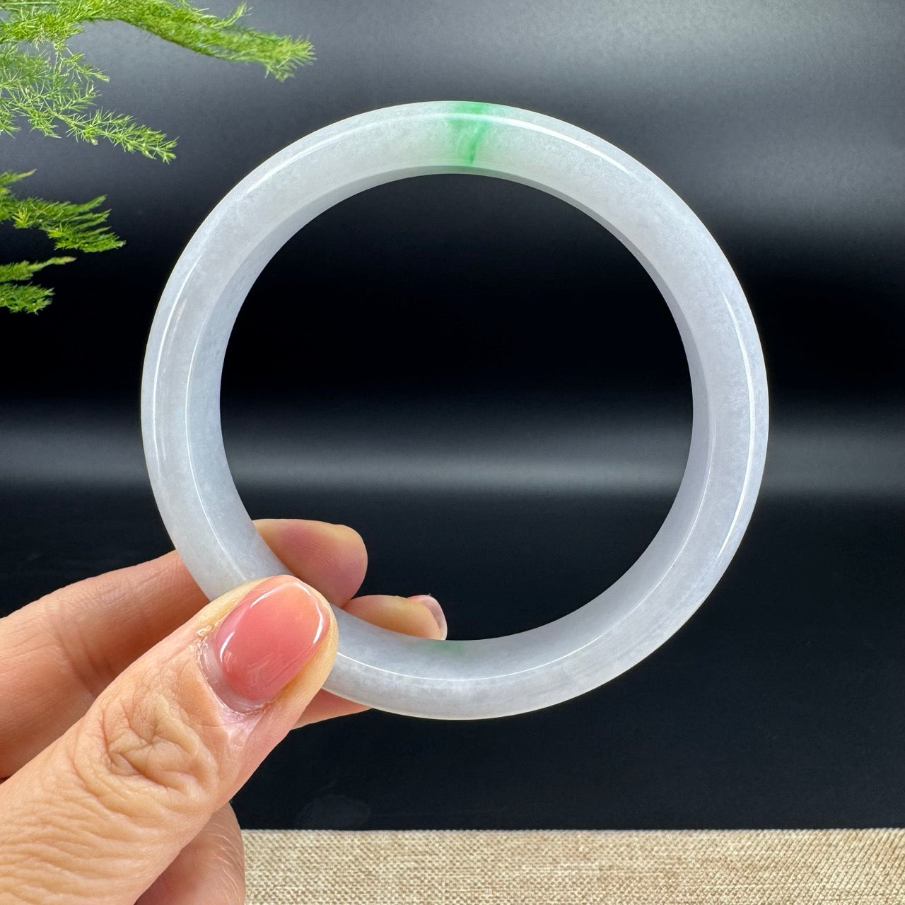 The bangle shape of the half round.The bangle color is white green.