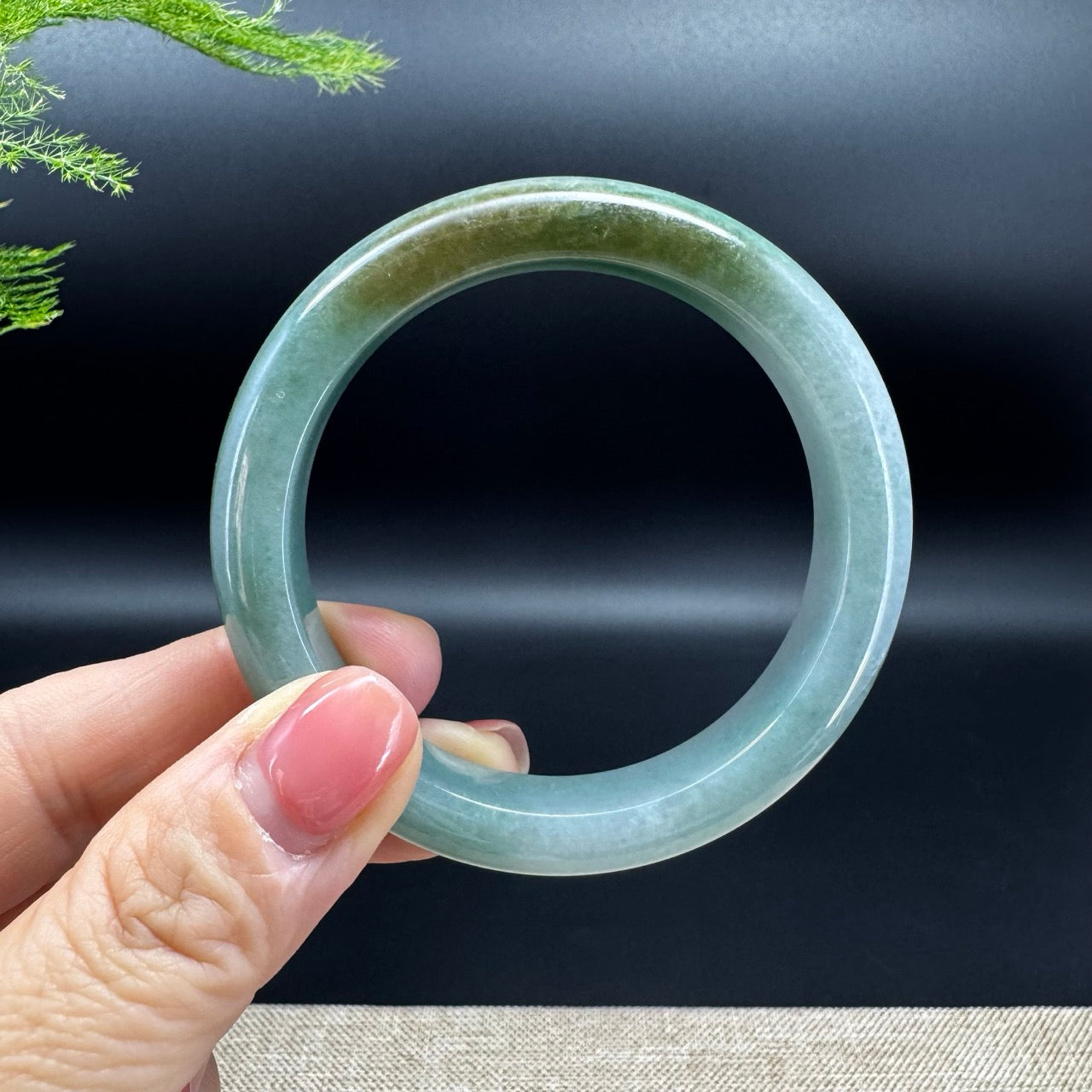 The bangle shape of the half round.The bangle color is green.