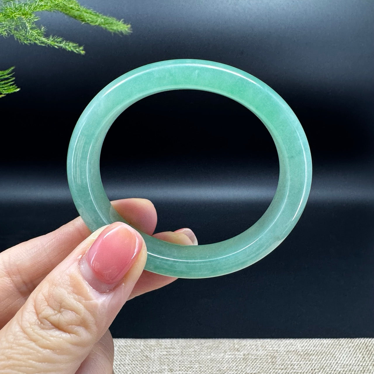 The bangle shape of the oval half round.The bangle color is green.