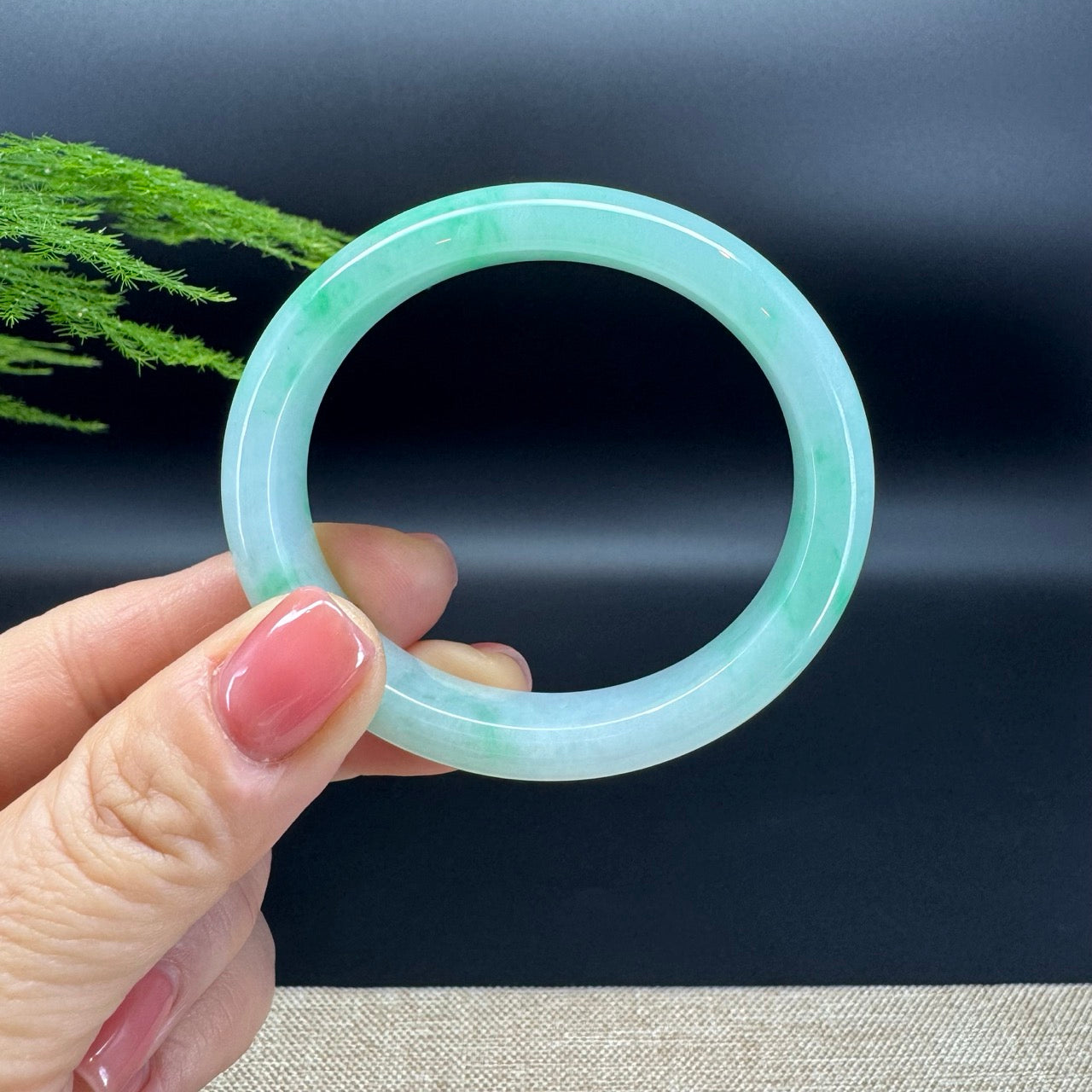  This bangle is made with very high quality genuine Burmese white green(BDC, moss in snow)Jadeite jade. The jade is extremely smooth in texture and presents icy apple green. 