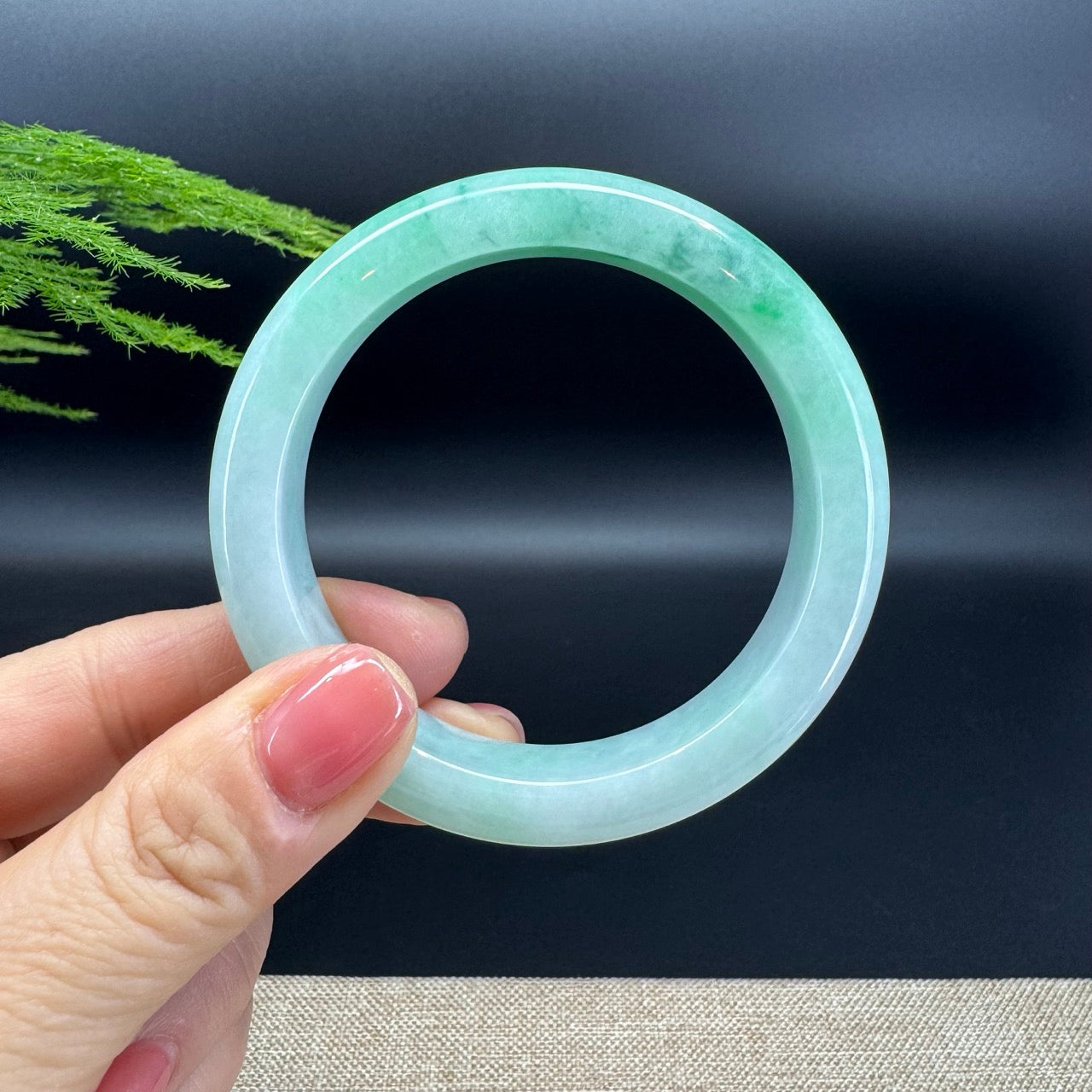 The bangle shape of the half round.The bangle color is blue green flower.