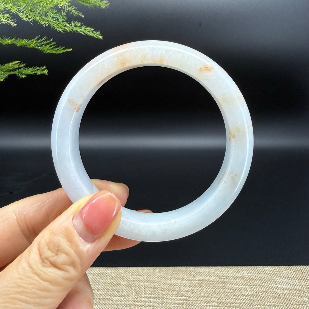 The bangle shape of the half round.The bangle color is light green and some sajin.
