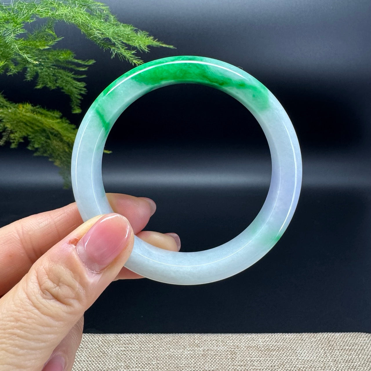 The bangle shape of the half round.The bangle color is white base and some lavender spicy green.