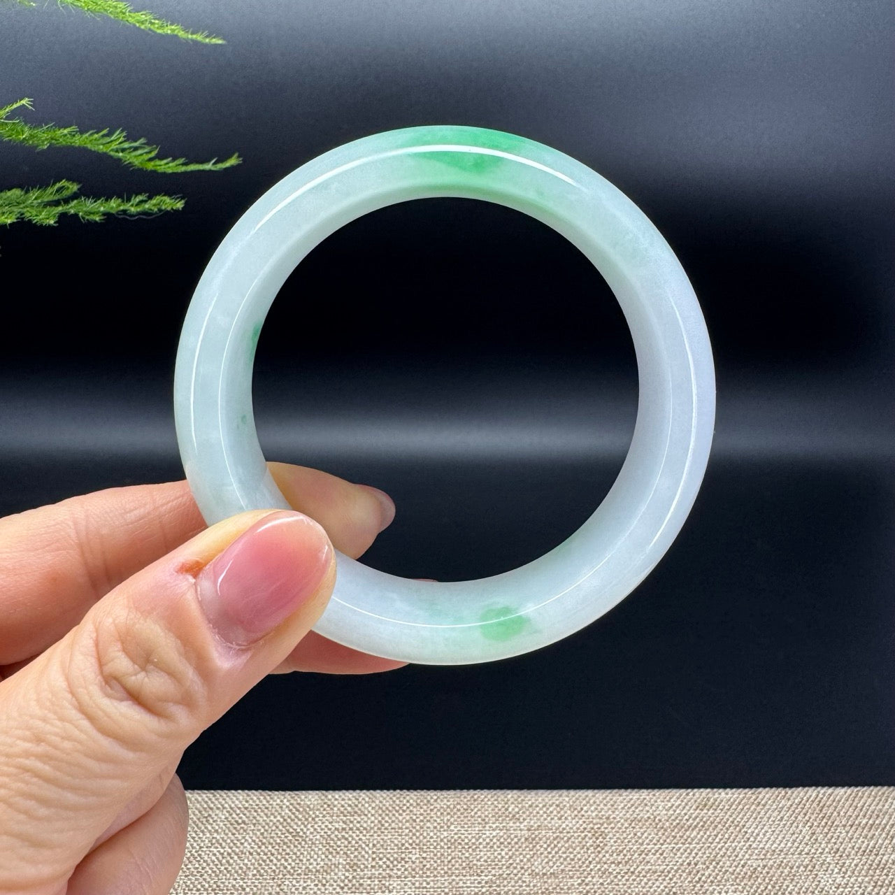 The bangle shape of the half round.The bangle color is white base and some spicy green.