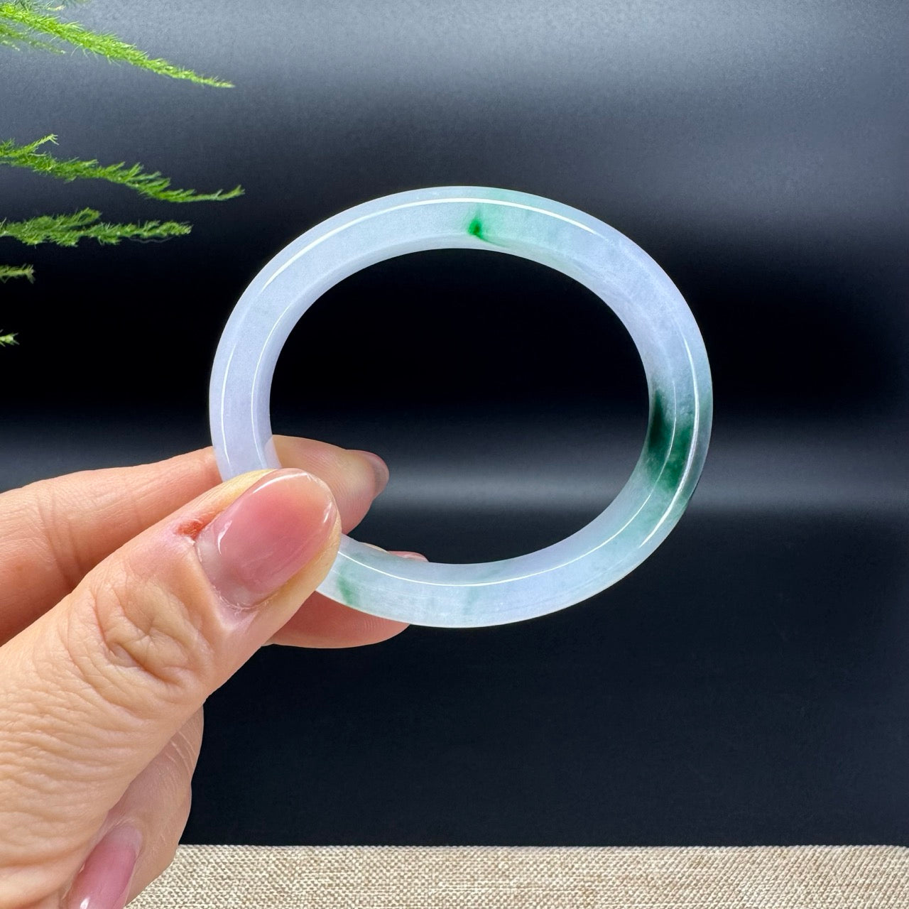 The bangle shape of the oval.The bangle color is icy forest green.
