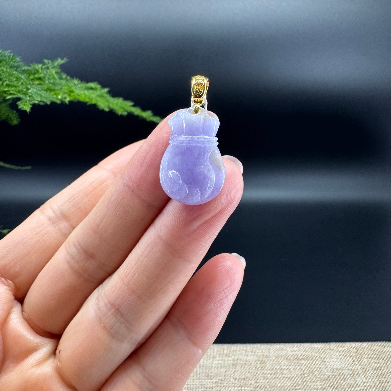 The shape of the pendant is money sack.The pendant color is lavender.