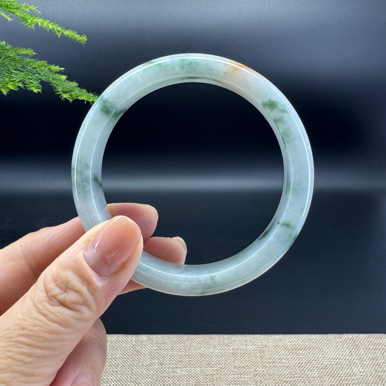 The bangle shape of the half round. The bangle colors are icy green and a bit of sajin.
