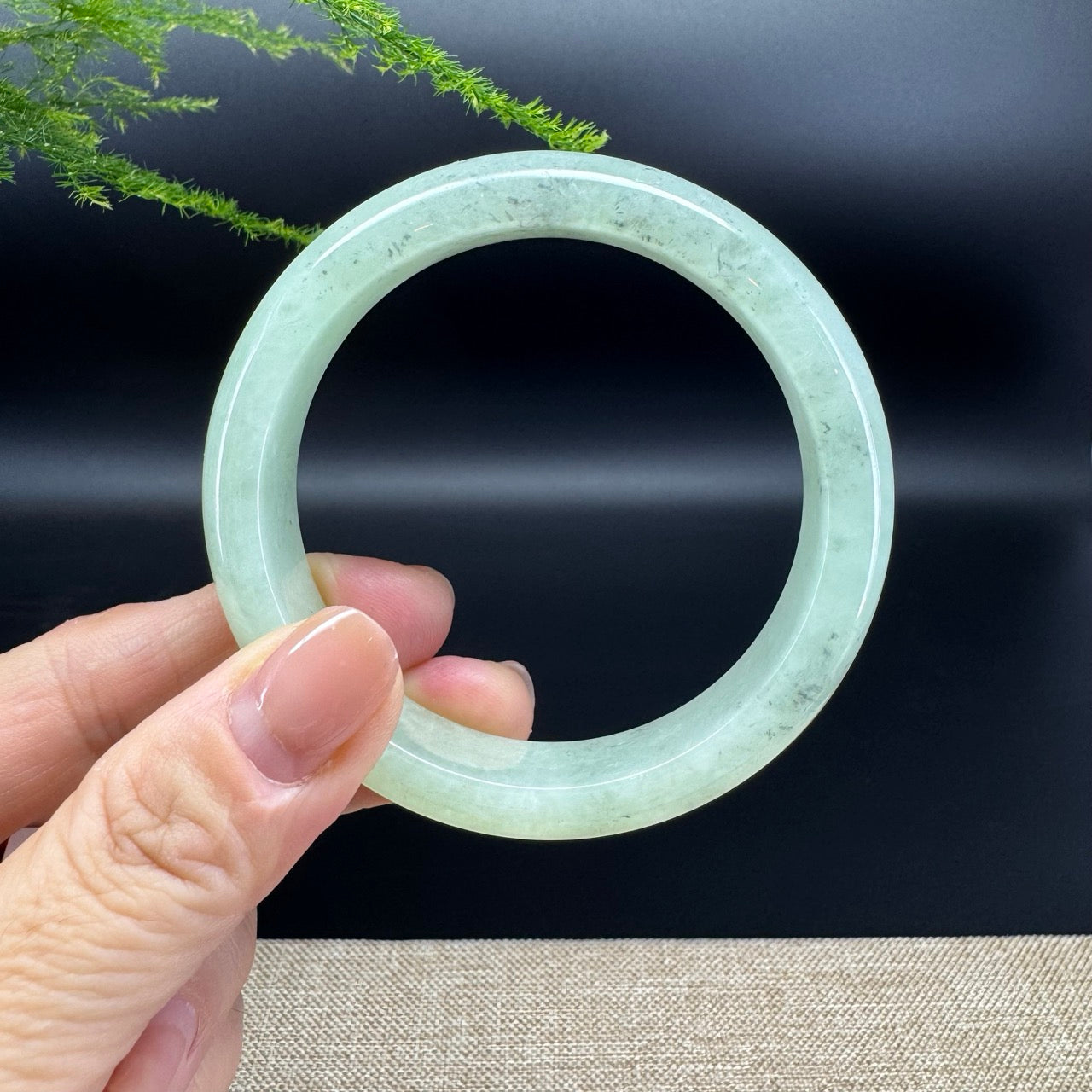 The bangle shape of the half round.The bangle color is green and some wuji.