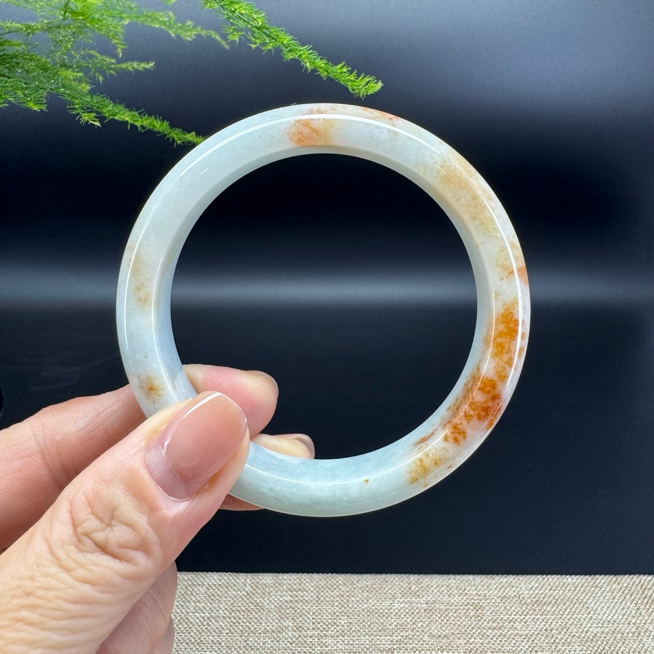 The bangle shape of the half round.The bangle color is orange green.