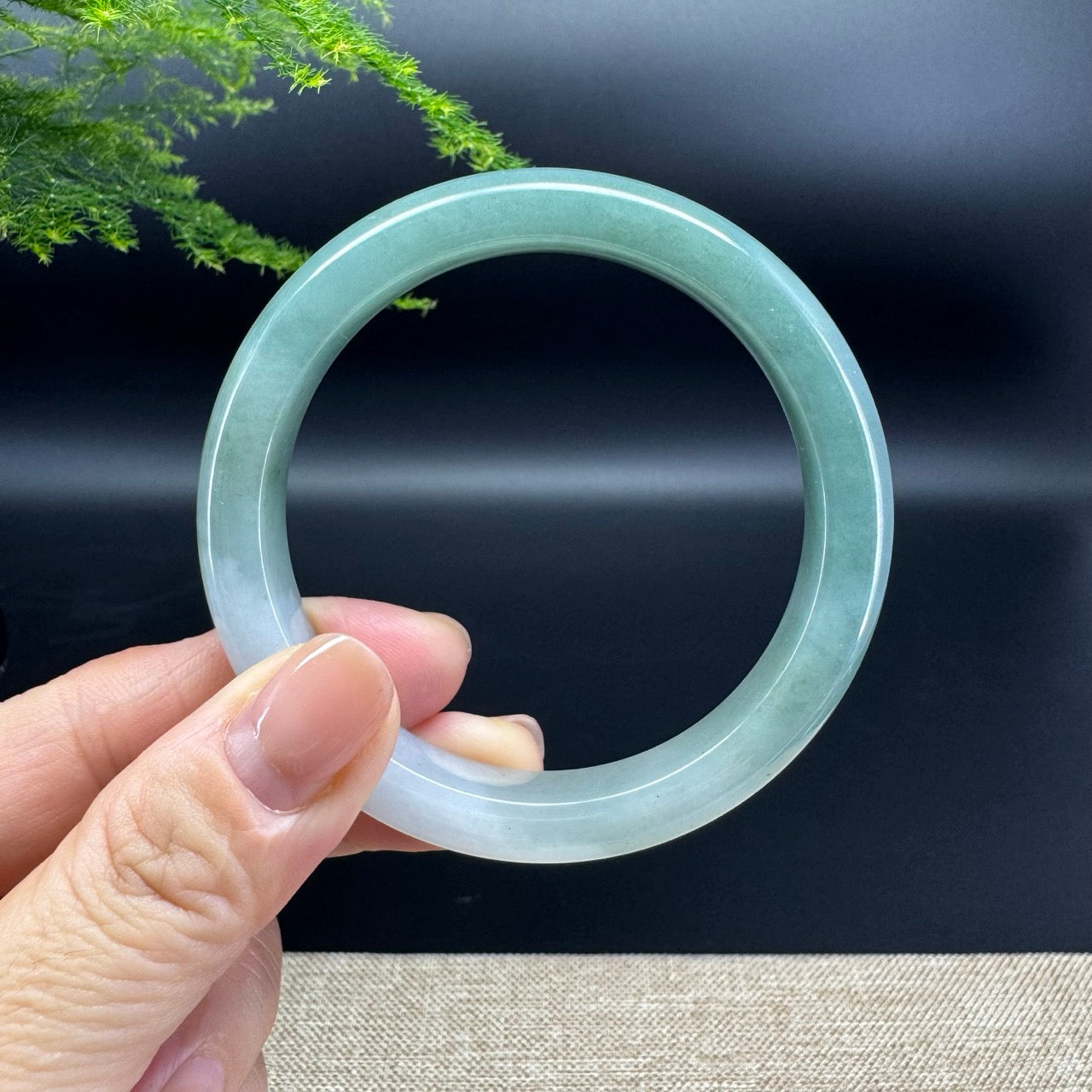 The bangle shape of the half round.The bangle color is white green.