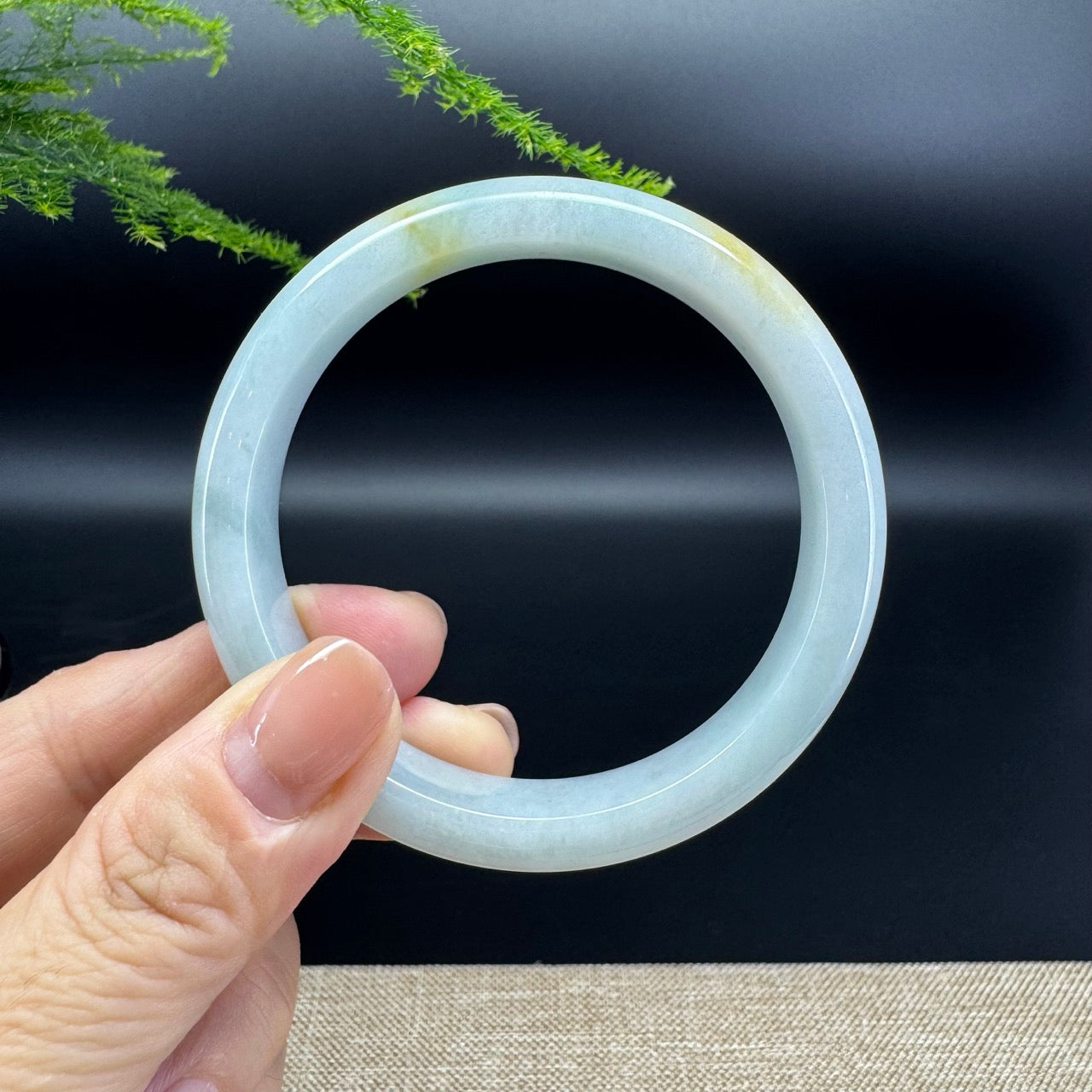 The bangle shape of he half round.The bangle color is yellow green.