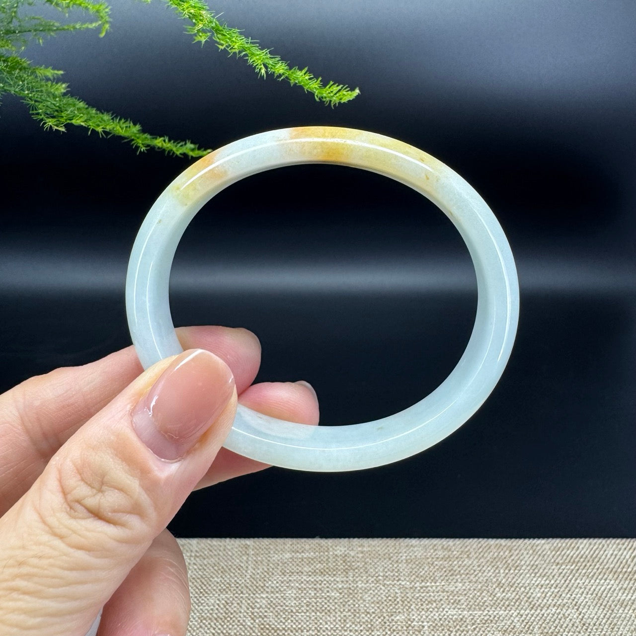 The bangle shape of oval.The bangle color is yellow green.