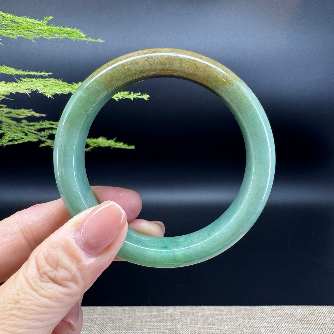 The bangle shape of the half round.The bangle color is yellow brown green.