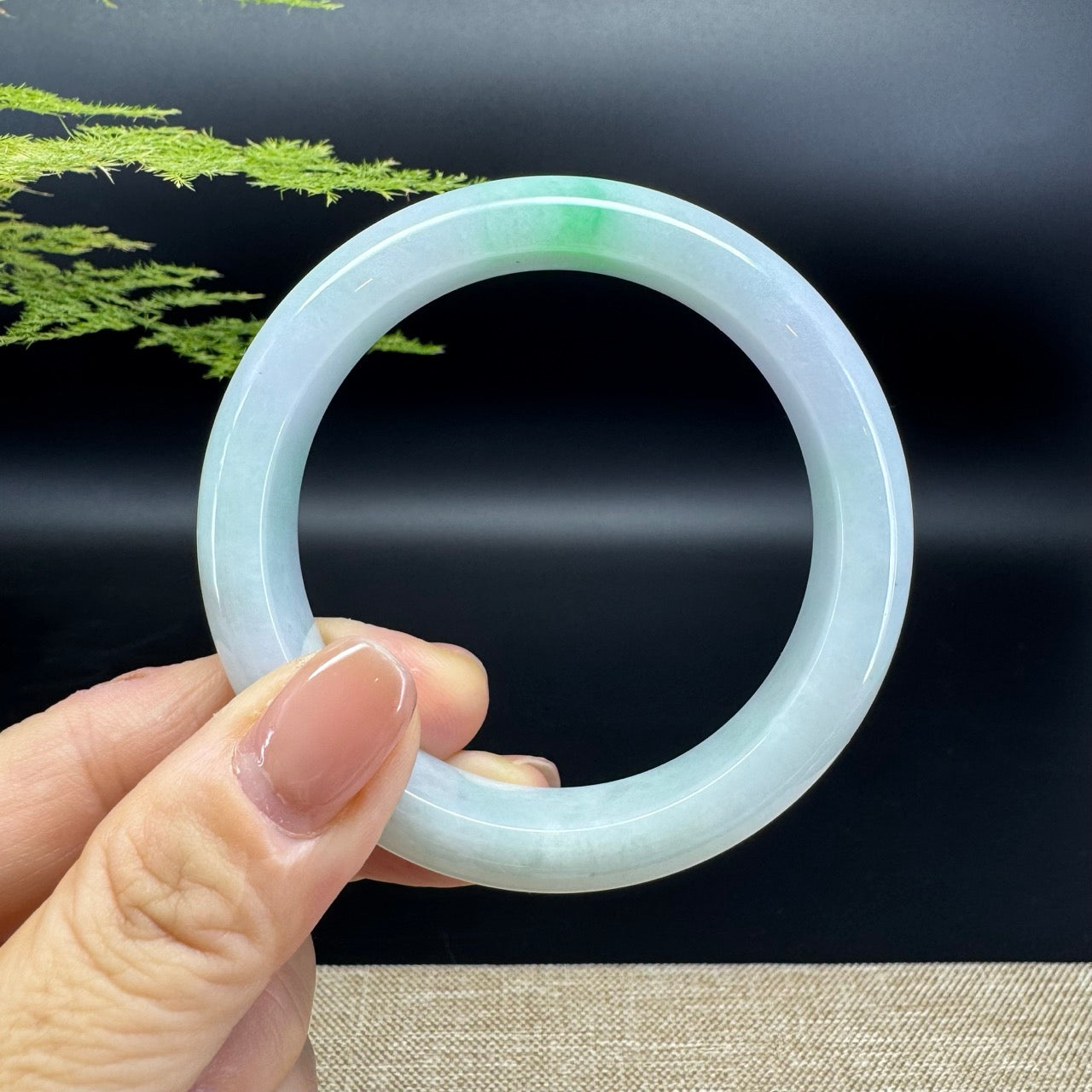 The bangle shape of the half round.The bangle color is white green.
