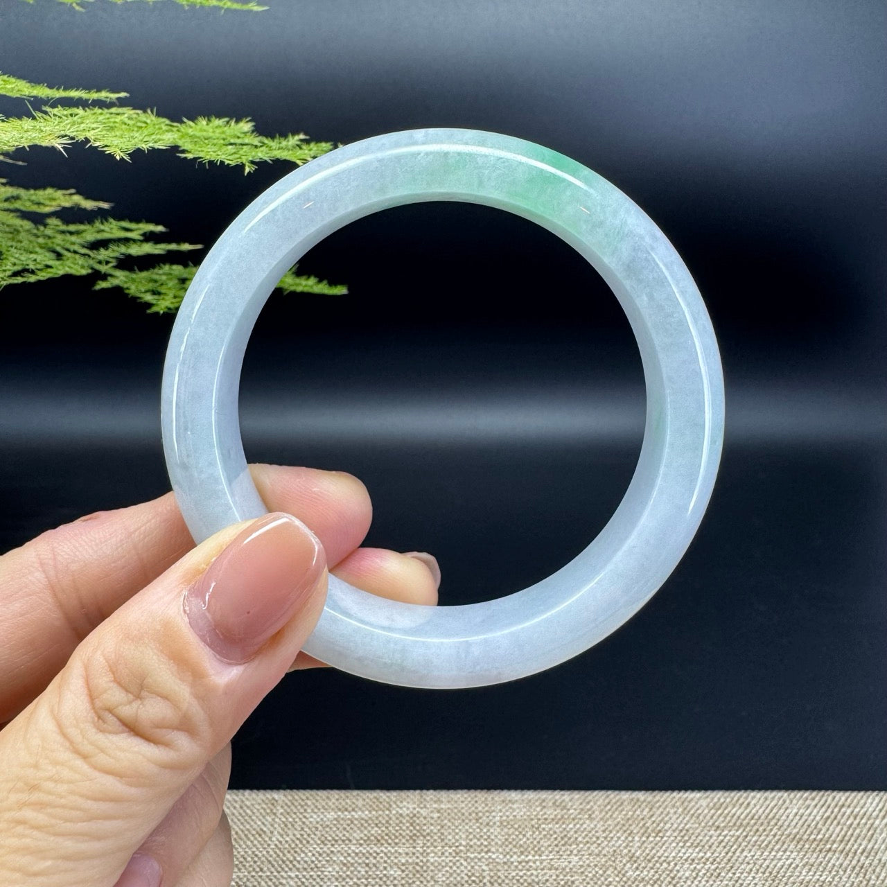 The bangle shape of the half round.The bangle color is white green.