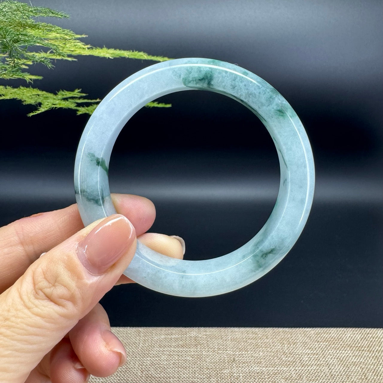 The bangle shape of the half round.The bangle color is icy blue green.