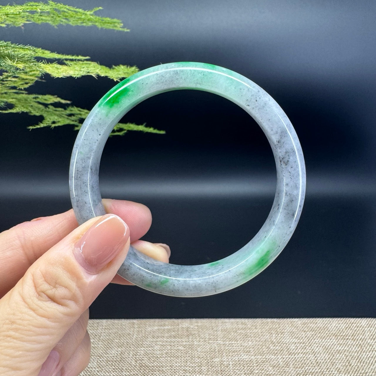 The bangle shape of the half round.The bangle color is icy wuji green.
