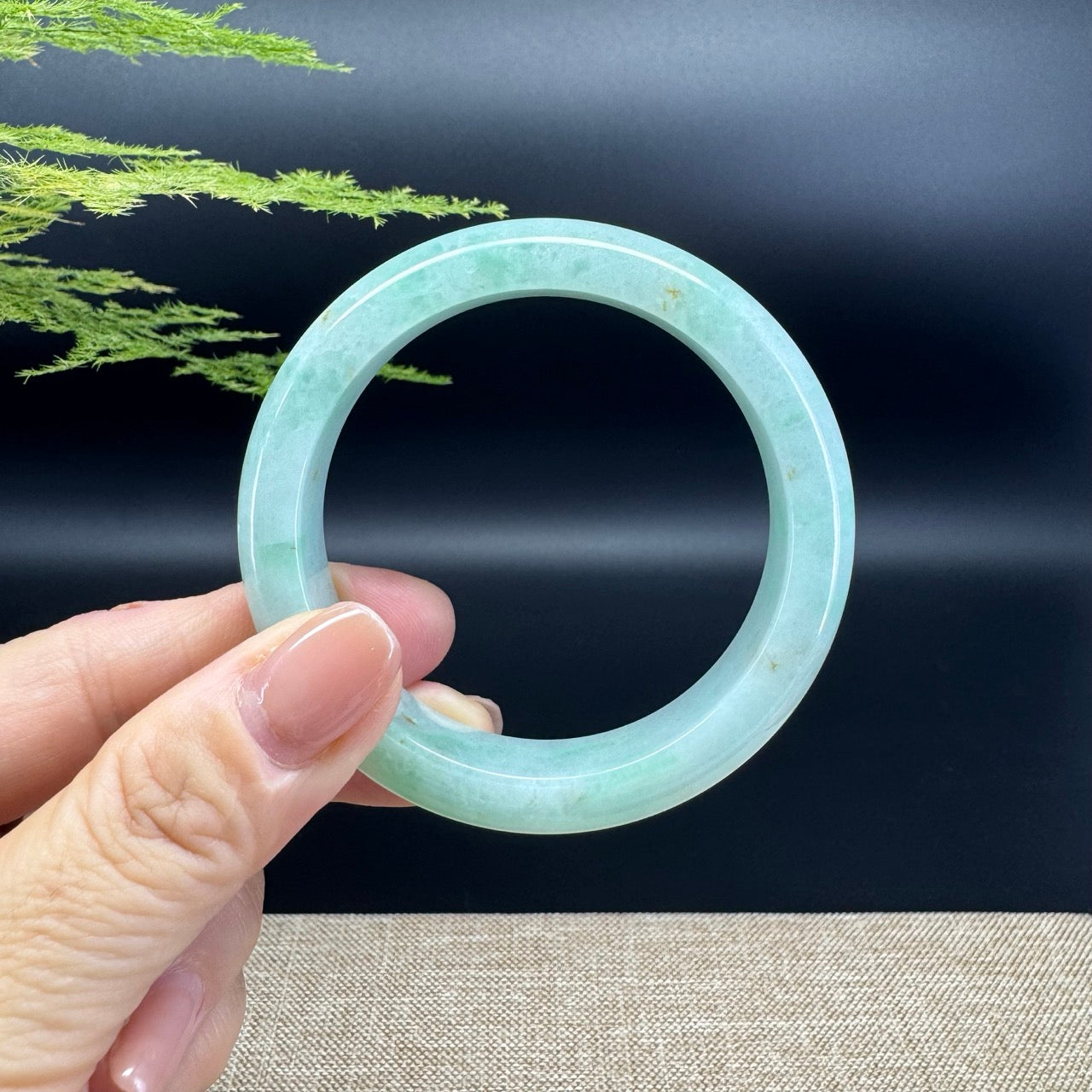 The bangle shape of the half round.The bangle color is green.