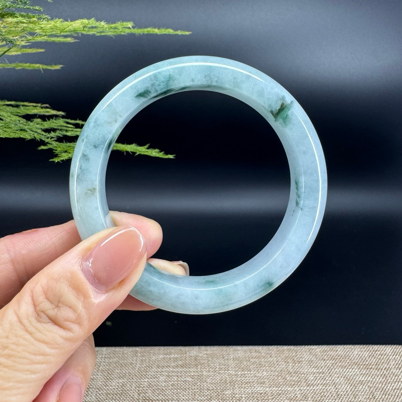 The bangle shape of the half round.The bangle color is icy blue green.