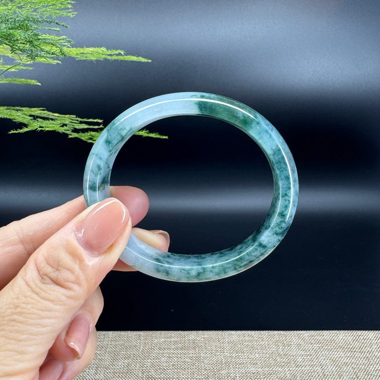 The bangle shape of the oval half round.The bangle color is icy blue green flower.