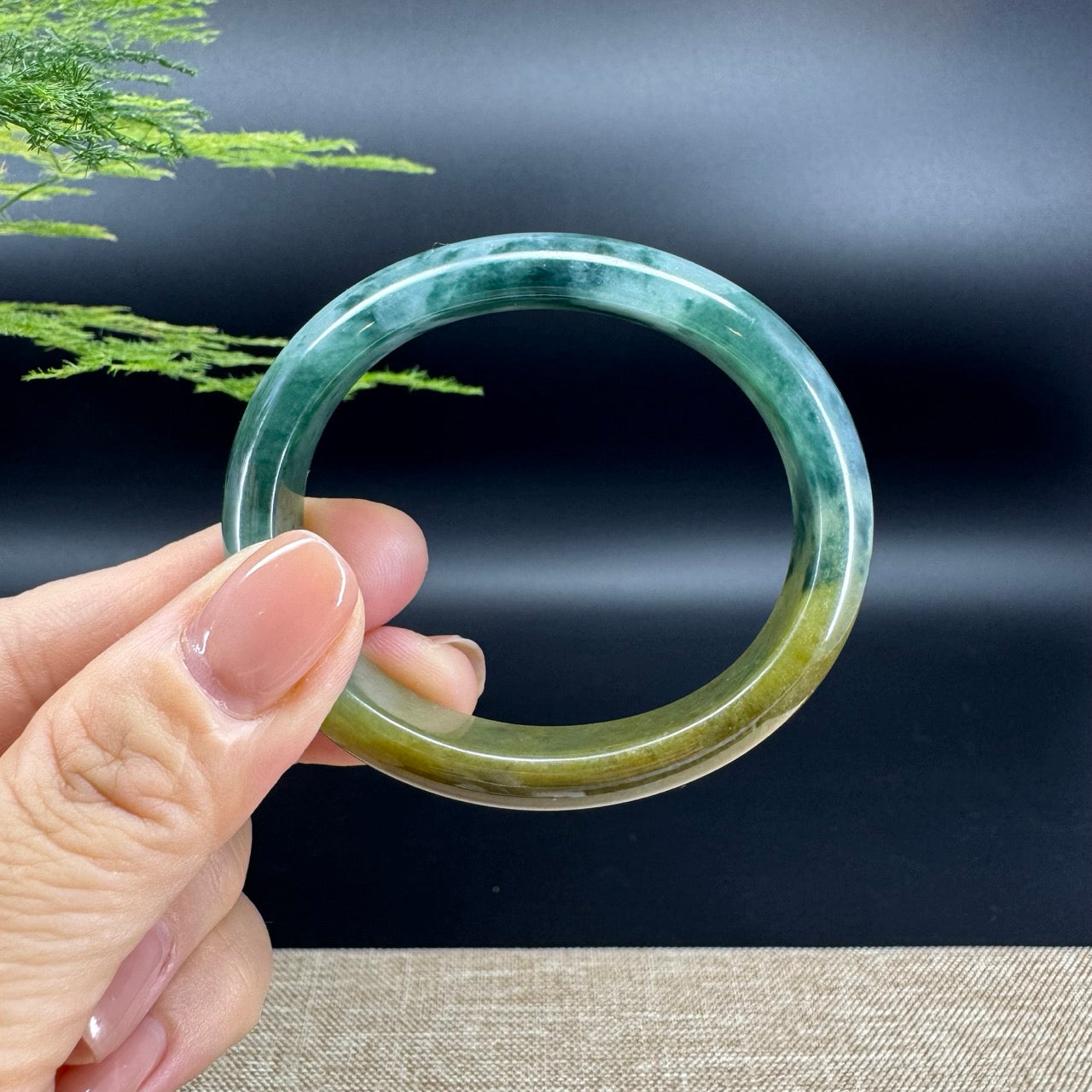 The bangle shape of the oval half round.The bangle color is yellow blue flower.