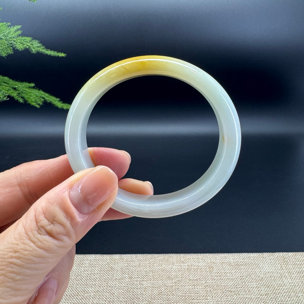 The bangle shape of half round.The bangle color is yellow green.