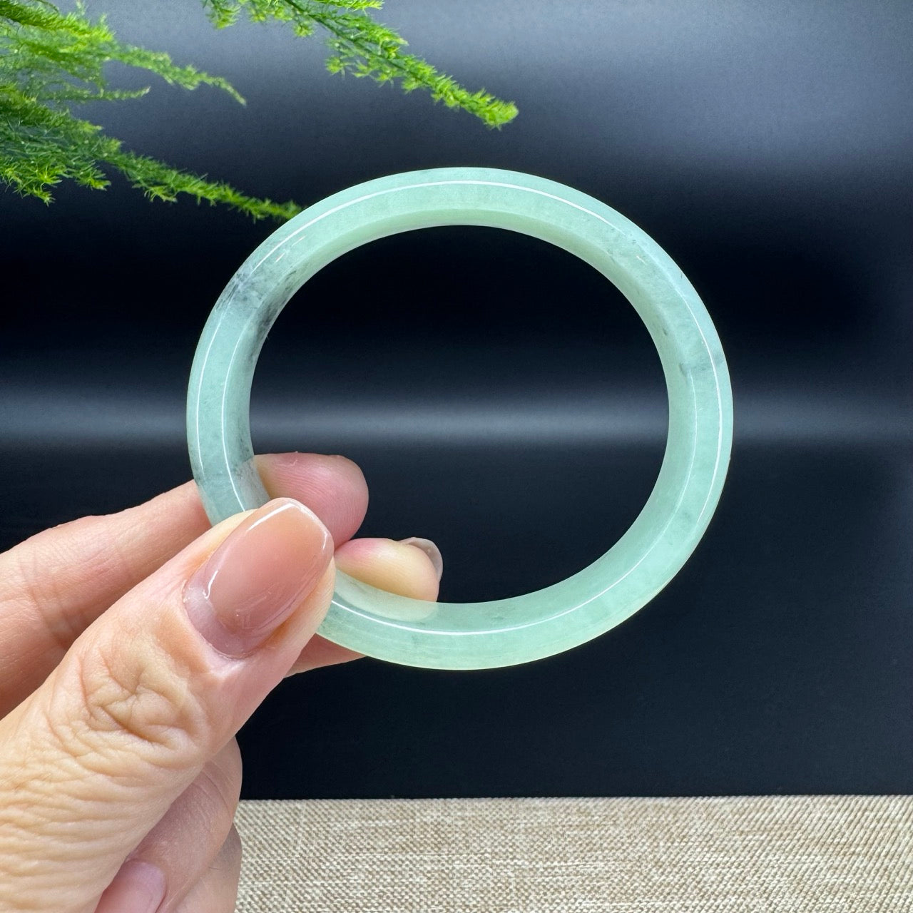 The bangle shape of the half round.The bangle color is light green and some wuji.