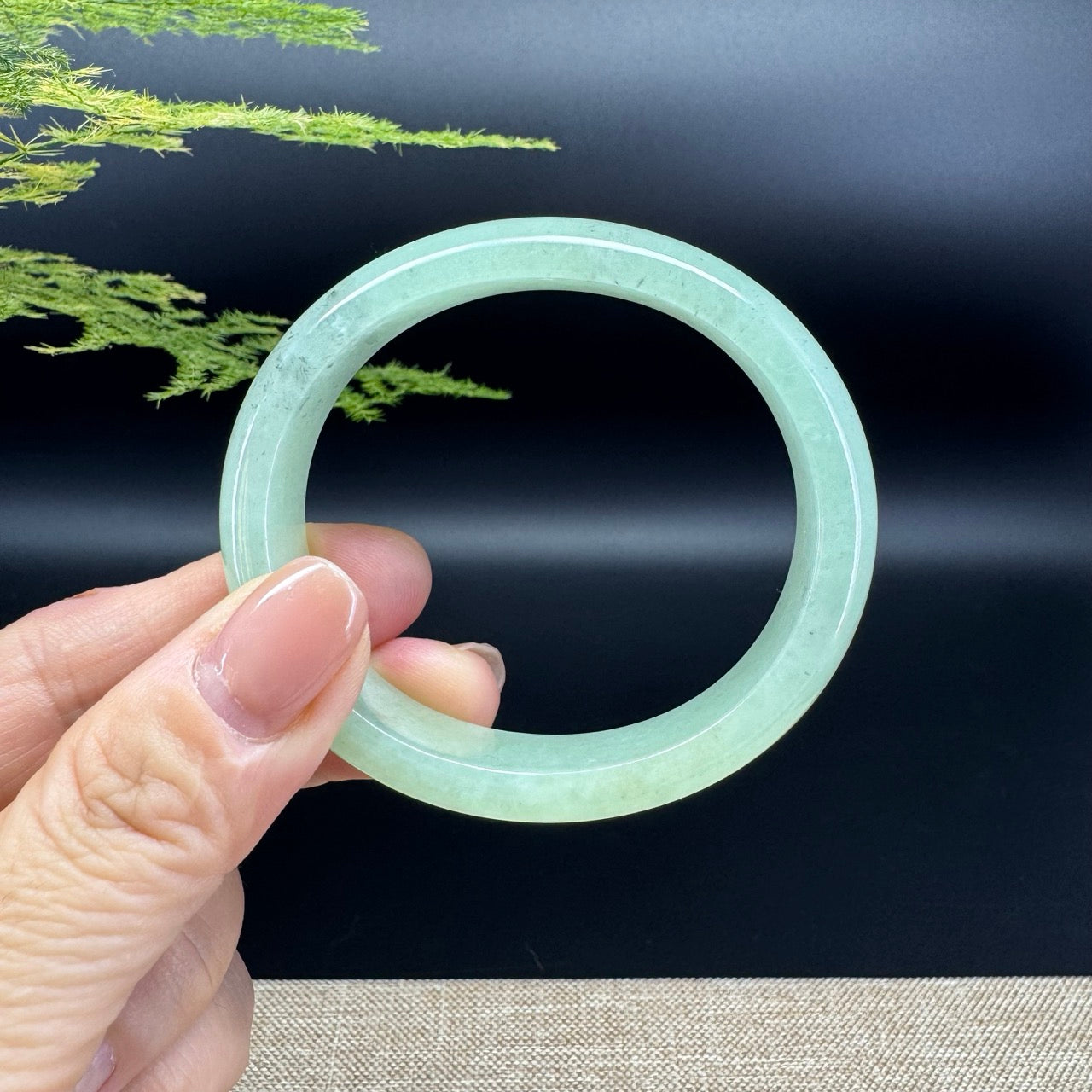 The bangle shape of the half round.The bangle color is icy green and some wuji.