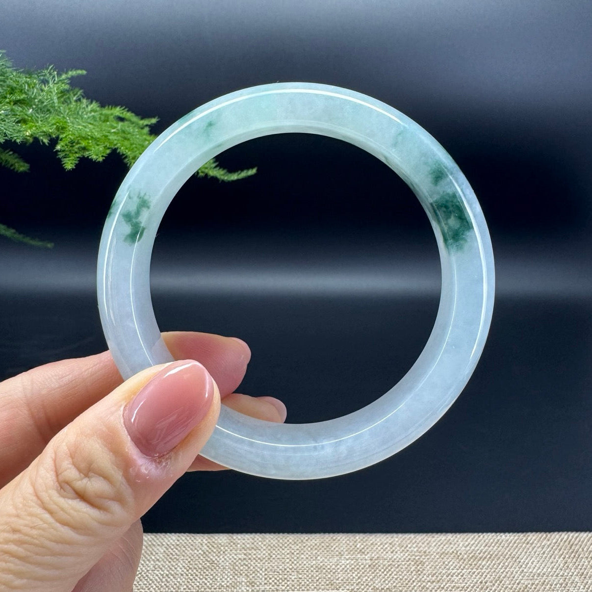 The bangle shape of the half round.The bangle color is icy blue green.