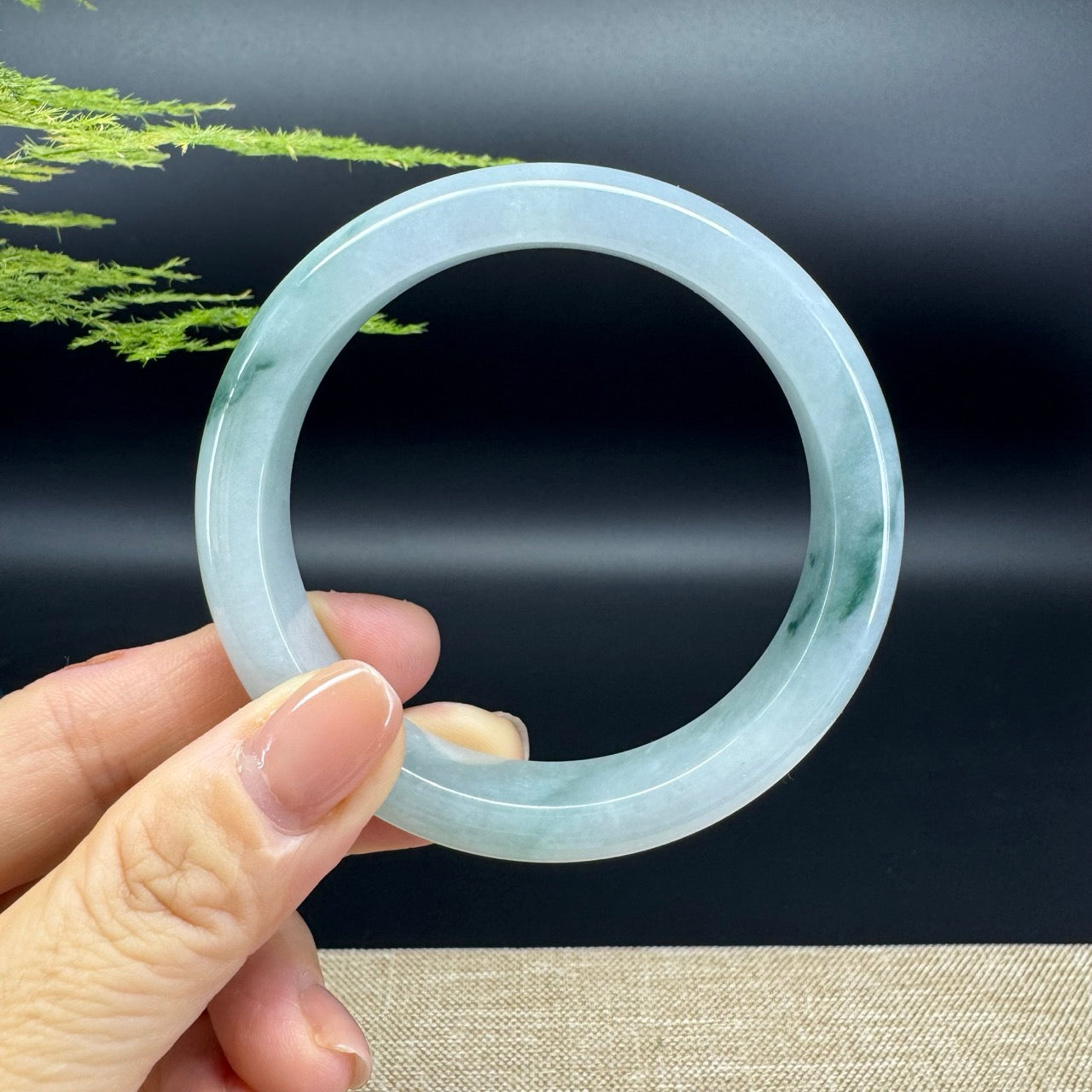 The bangle shape of the half round.The bangle color is icy blue green.