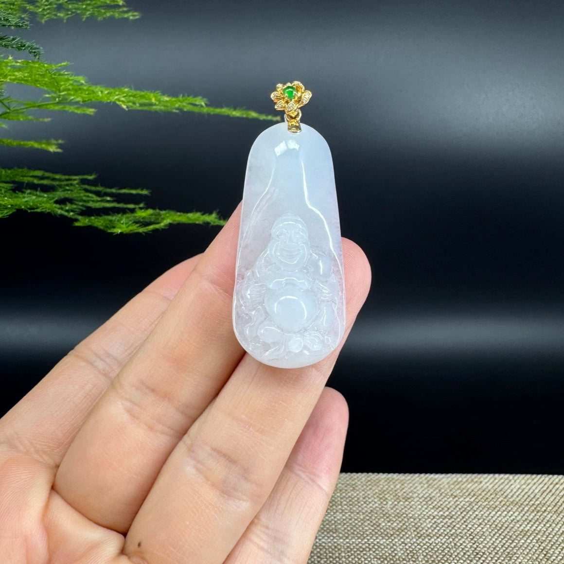 The pendant shape of the buddha.The pendant color is icy.