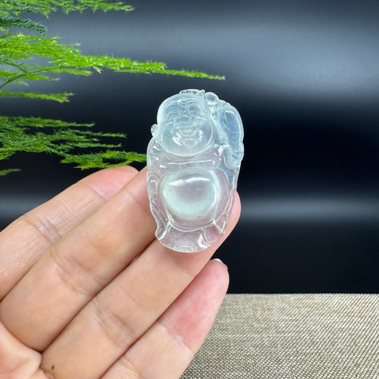 The pendant shape of the buddha.The pendant color is icy.