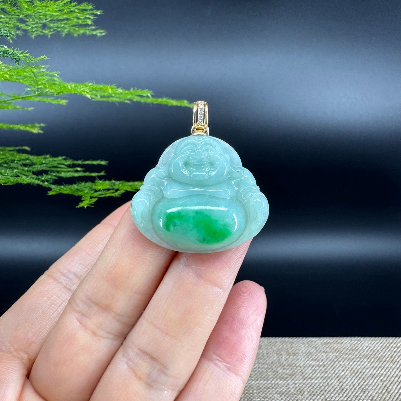 The pendant shape of the buddha.The pendant color is blue green.