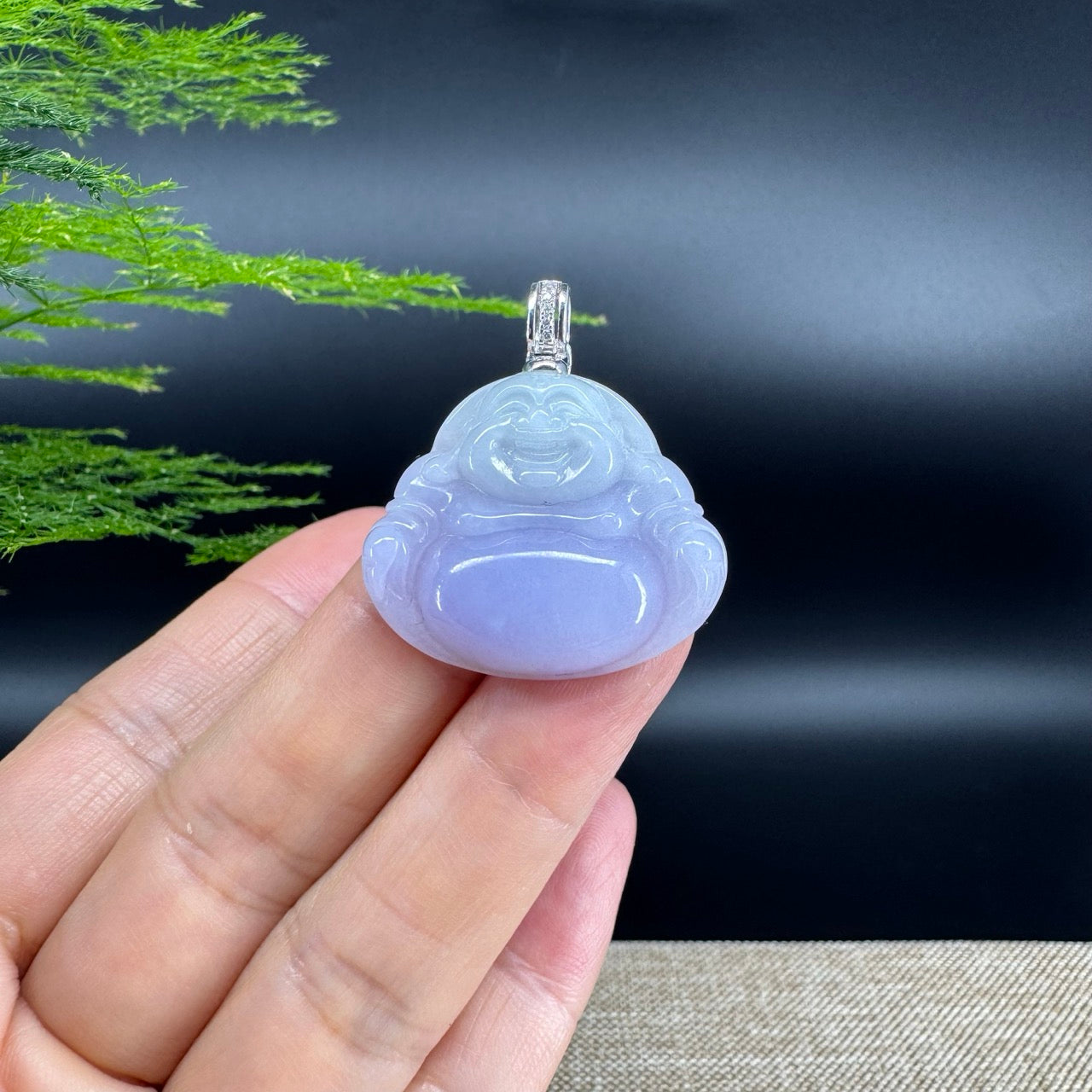 The pendant shape of the buddha.The pendant color is lavender.