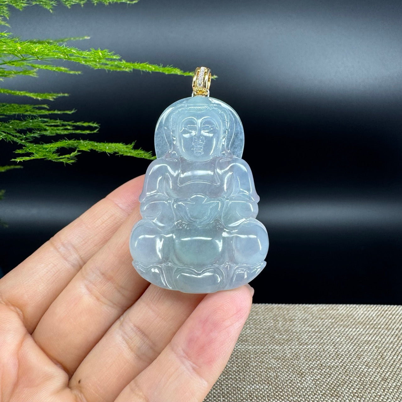 The pendant shape of the buddha.The pendant color is icy.