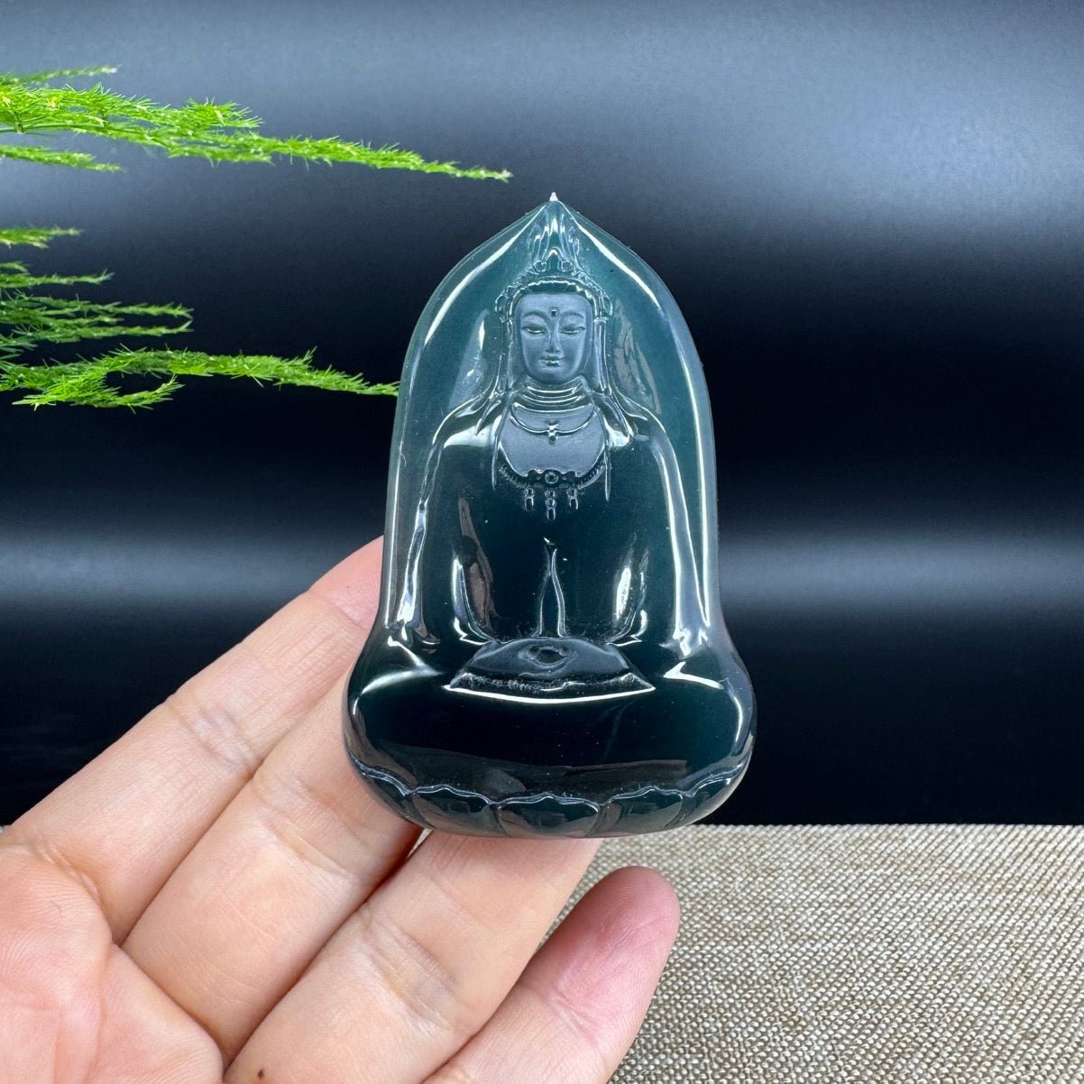 The pendant shape of the guanyin.The pendant color is blue black.