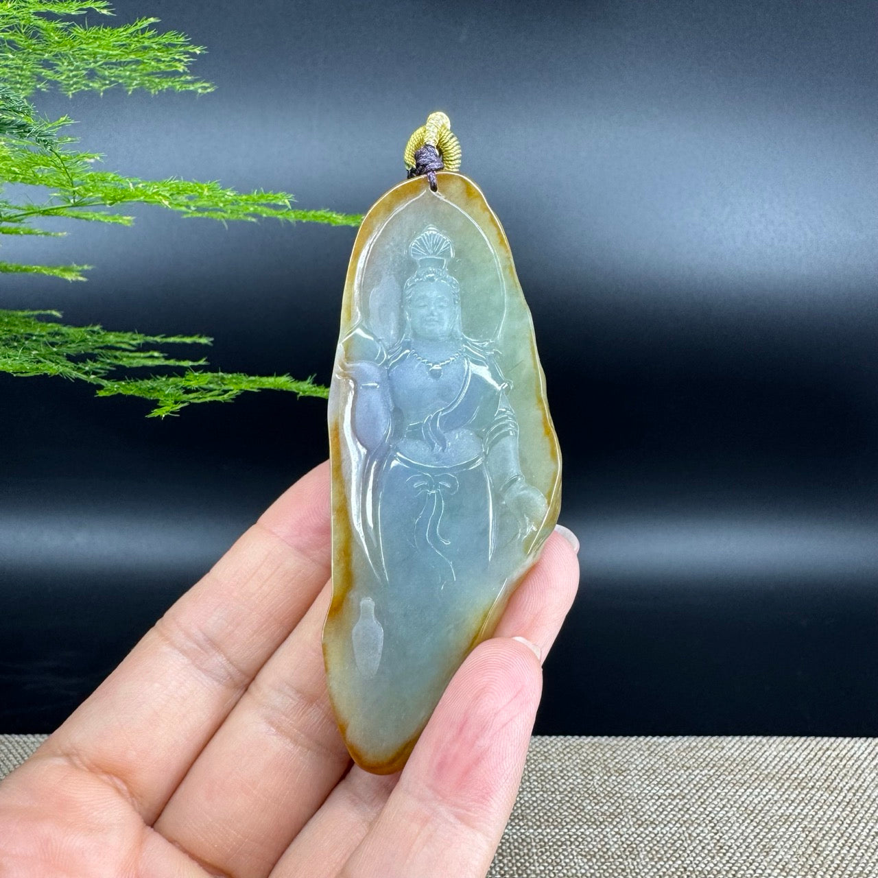 The pendant shape of the guanyin.The pendant color is yellow green.
