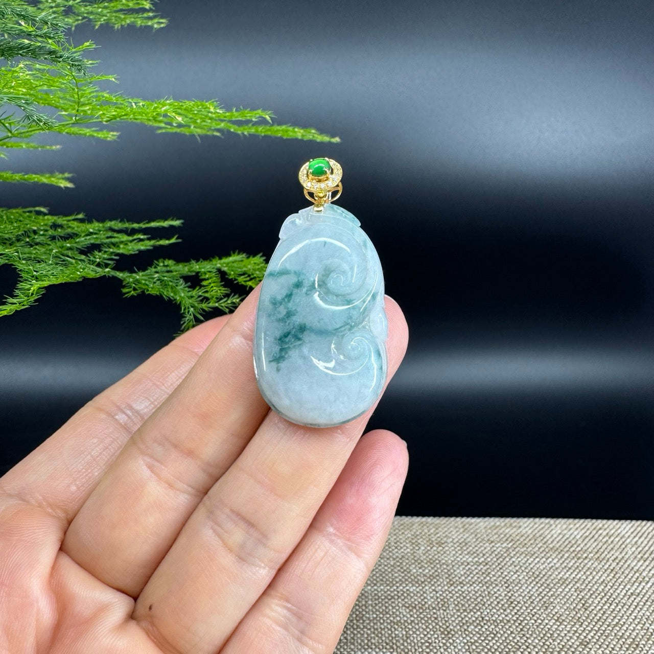 The pendant shape of the ruyi.The pendant color is icy blue green.