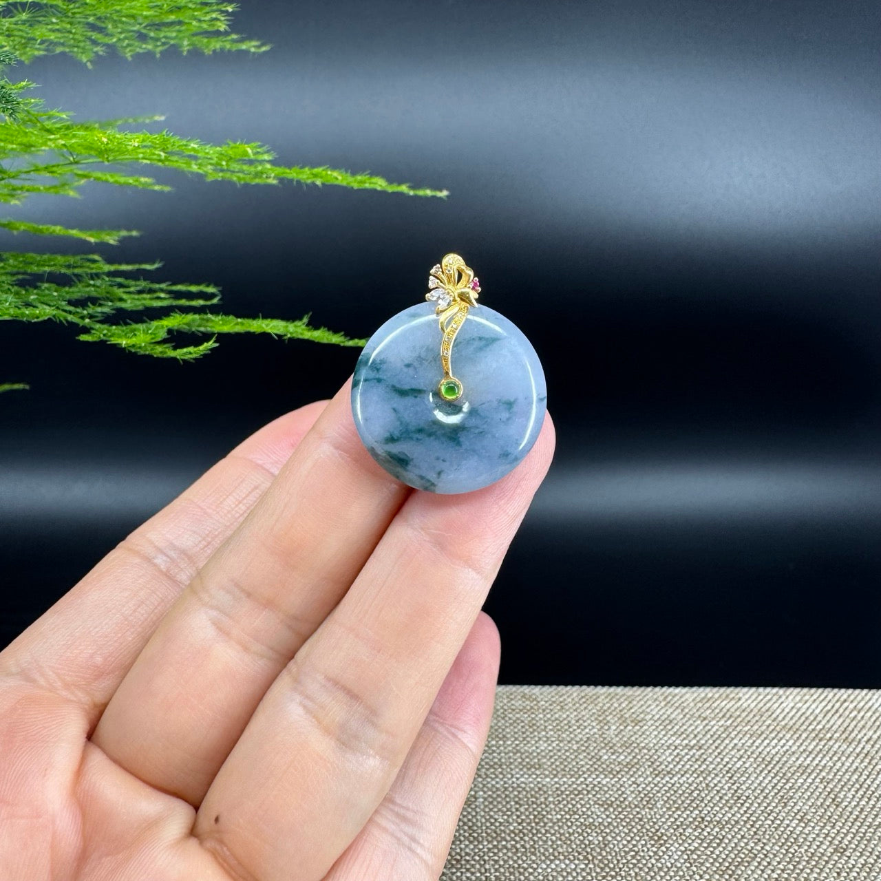 The pendant shape of the koukou.The pendant color is blue green.