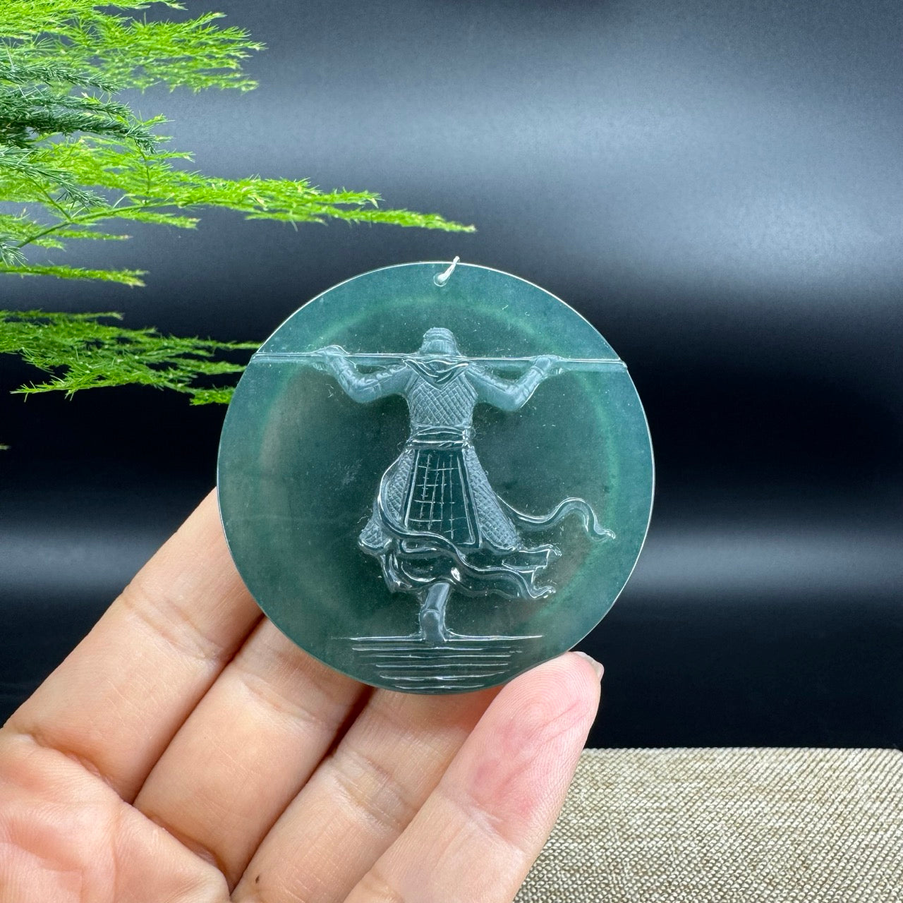 The pendant shape of the monkey king.The pendant color is blue green.