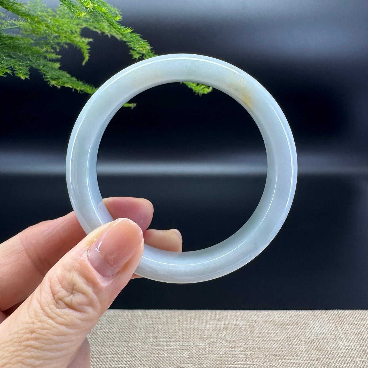 The bangle shape of the half round.The bangle  color is green and a bit of sajin.